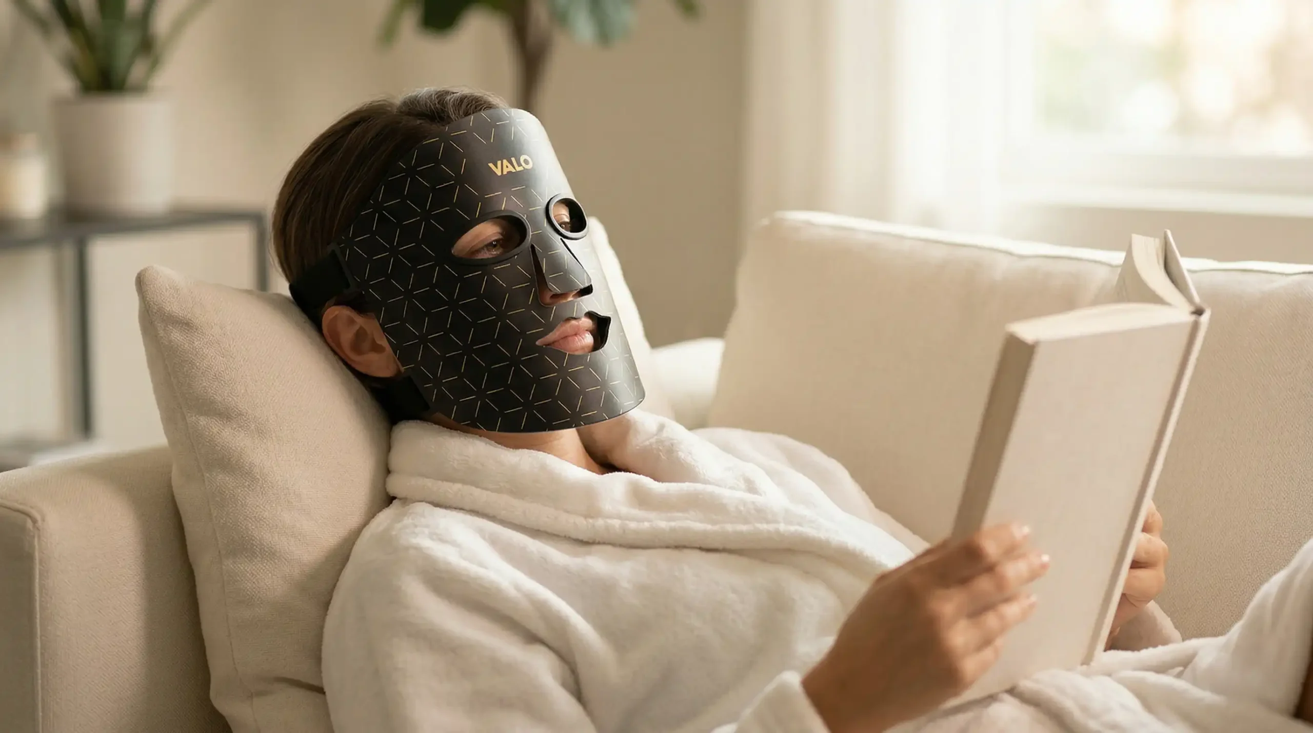 Woman wearing LED face mask at home skincare routine red light therapy 2026